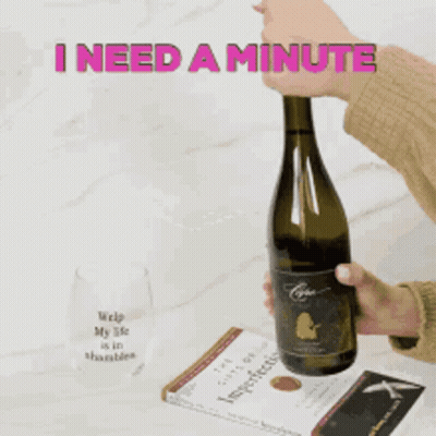 A Person Is Opening A Bottle Of Wine With The Words I Need A Minute Behind Them GIF