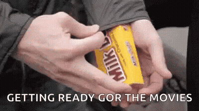 A Person Is Opening A Box Of Milky Way Candy GIF