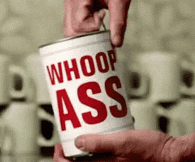 A Person Is Opening A Can Of Whoop Ass Soup . GIF