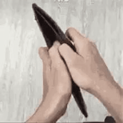 A Person Is Opening An Empty Wallet With Their Hands . GIF