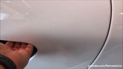 A Person Is Opening The Door Of A White Car With Youtube.com/namastecar Written On The Bottom GIF