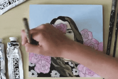 A Person Is Painting A Picture With A Tube Of Golden Acrylic Paint GIF