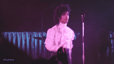 A Person Is Playing A Keyboard With Purple Lights Behind Them GIF