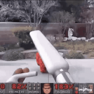 A Person Is Playing A Video Game With A Remote Control In Their Hands . GIF