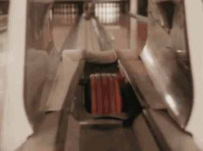 A Person Is Playing Bowling In A Bowling Alley With A Red Ball In The Middle . GIF