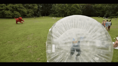 A Person Is Playing In A Bubble In A Park GIF