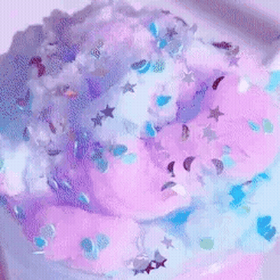 A Person Is Playing With A Purple And Blue Slime . GIF