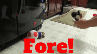 A Person Is Playing With A Stuffed Animal In Front Of A Refrigerator With The Word Fore Written On The Floor GIF