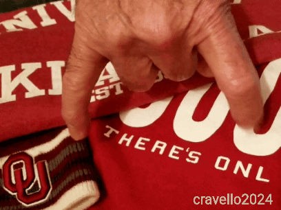 A Person Is Pointing At A Red Shirt That Says There 'S One GIF