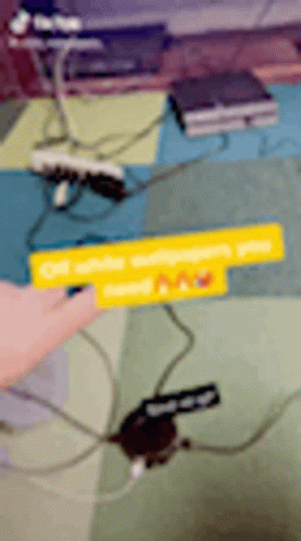 A Person Is Pointing At A Sign That Says Off White GIF