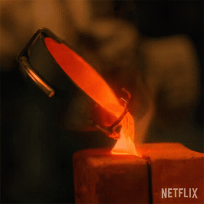A Person Is Pouring Molten Metal Into A Piece Of Wood . GIF