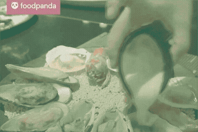 A Person Is Pouring Sauce Into A Plate Of Seafood With A Foodpanda Logo In The Background GIF