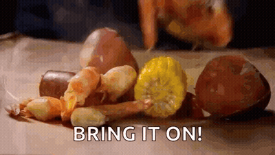 A Person Is Preparing A Crawfish Boil With Shrimp , Corn , Potatoes , Onions And Sausage . GIF