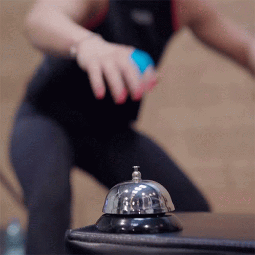 A Person Is Pressing A Bell That Says ' A ' On It GIF