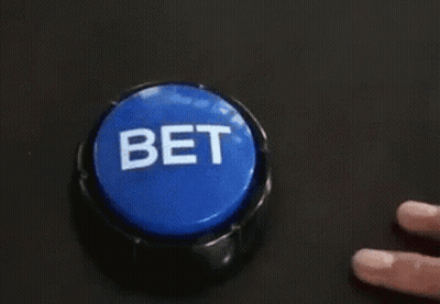 A Person Is Pressing A Blue Button That Says Bet On It . GIF