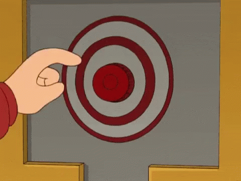 A Person Is Pressing A Red Button With A Target In The Background GIF