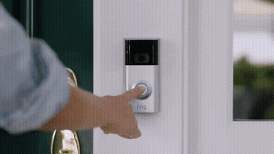 A Person Is Pressing A Ring Doorbell Button On A Door GIF