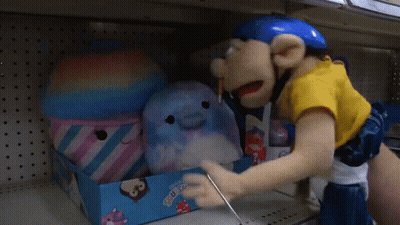 A Person Is Putting Stuffed Animals In A Box That Says ' Squishee ' On It GIF