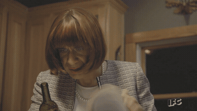 A Person Is Reading A Book With The Letters Lfc On The Back Of Their Jacket GIF