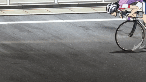 A Person Is Riding A Bike Down A Street GIF