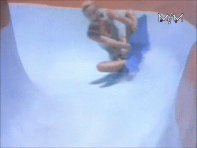A Person Is Riding A Blue Board Down A Water Slide With The Letters Mm Visible GIF