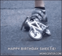 A Person Is Riding A Small Bicycle On A Street . GIF