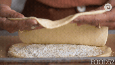A Person Is Rolling A Piece Of Dough With Food52 On The Bottom Right GIF