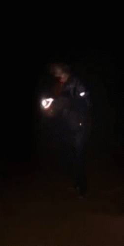 A Person Is Screaming In The Dark With Their Mouth Wide Open GIF