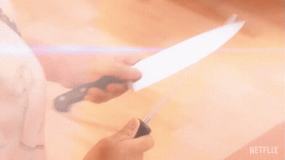 A Person Is Sharpening A Knife With A Netflix Logo Behind Them GIF