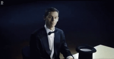 A Person Is Sitting At A Table With A Hat On And Smoke Coming Out Of It . GIF