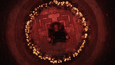 A Person Is Sitting In A Circle Of Lights GIF