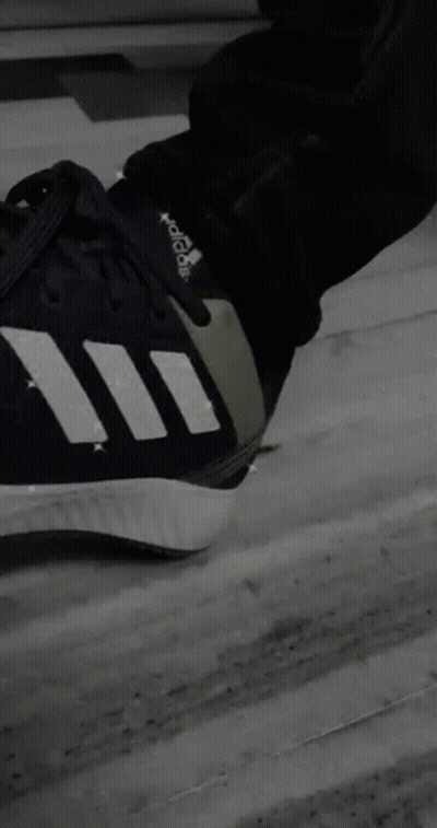 A Person Is Sitting On A Couch Wearing Adidas Shoes GIF