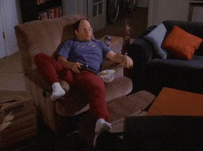 A Person Is Sitting On A Couch With A Shelf Full Of Sodas And Snacks Including A Can Of Dg GIF