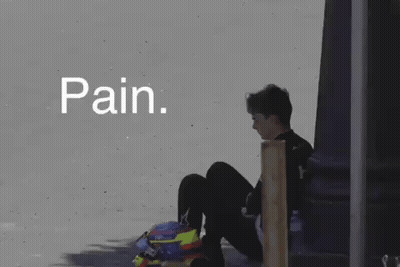 A Person Is Sitting On The Ground With A Helmet On Their Head And The Word Pain Written Above Them . GIF
