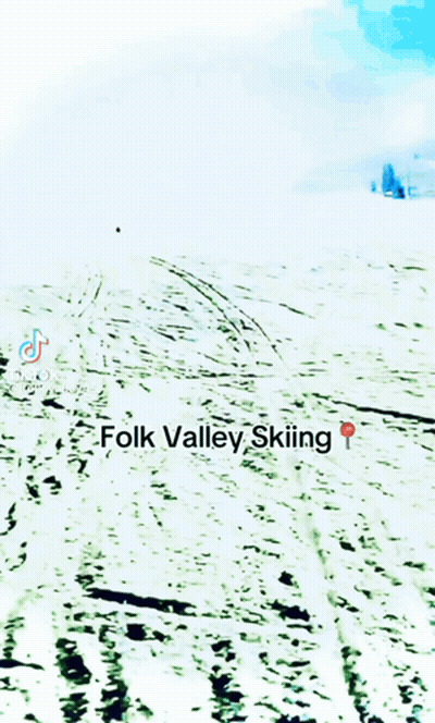 A Person Is Skiing Down A Snow Covered Slope With The Words Folk Valley Skiing Below Them GIF
