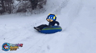 A Person Is Sledding Down A Snowy Hill With Monkey Baby Written On The Bottom Of The Picture GIF