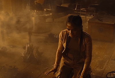 A Person Is Standing In A Dark Room In A Foggy Room . GIF