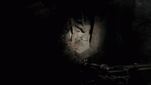 A Person Is Standing In A Dark Room With A Blue Light Shining On Them GIF