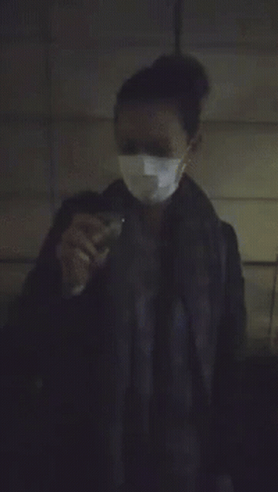 A Person Is Standing In A Dark Room With A Bright Light Coming From Behind Them GIF