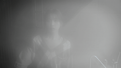 A Person Is Standing In A Foggy Room With The Letter N In The Foreground GIF