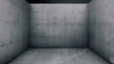 A Person Is Standing In A Room With A Concrete Wall And A Gray Floor . GIF