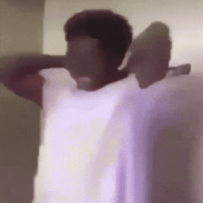 A Person Is Standing In A Room With Their Arms Outstretched And A Purple Background GIF