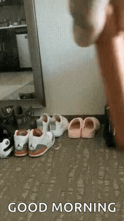 A Person Is Standing In Front Of A Bunch Of Shoes On The Floor And Saying `` Good Morning '' . GIF