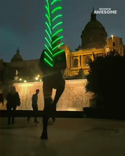 A Person Is Standing In Front Of A Fountain With A Sign That Says Awesome On It GIF