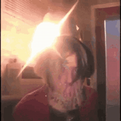 A Person Is Standing In Front Of A Fridge With A Light Coming Out Of The Fridge . GIF