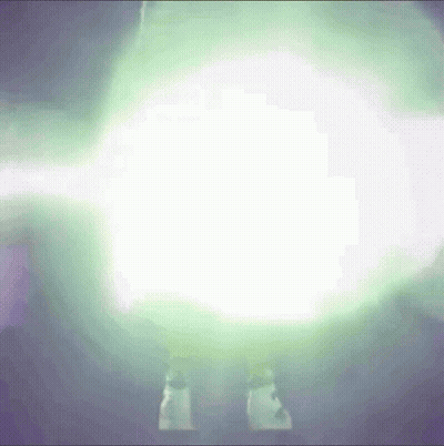 A Person Is Standing In Front Of A Glowing Light GIF