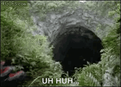 A Person Is Standing In Front Of A Hole In The Ground With The Words Uh Huh Written On It . GIF