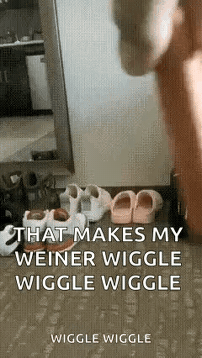 a person is standing in front of a mirror with a bunch of shoes on the ground .
