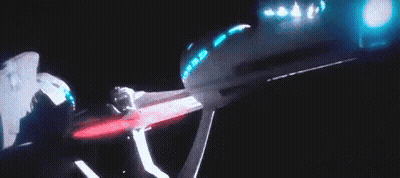 A Person Is Standing In Front Of A Projector Screen With Blue Lights . GIF