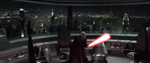A Person Is Standing In Front Of A Red Light GIF